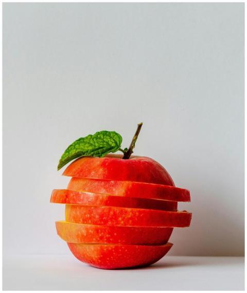 Artistic stack of sliced apple pieces with a fresh