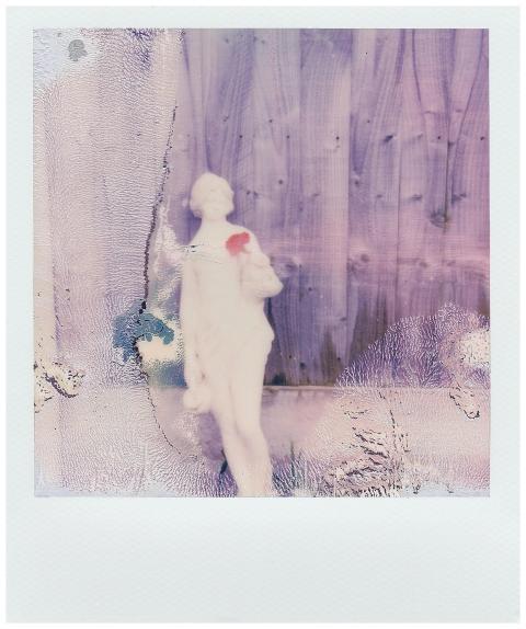 Vintage Polaroid of a white statue with abstract t