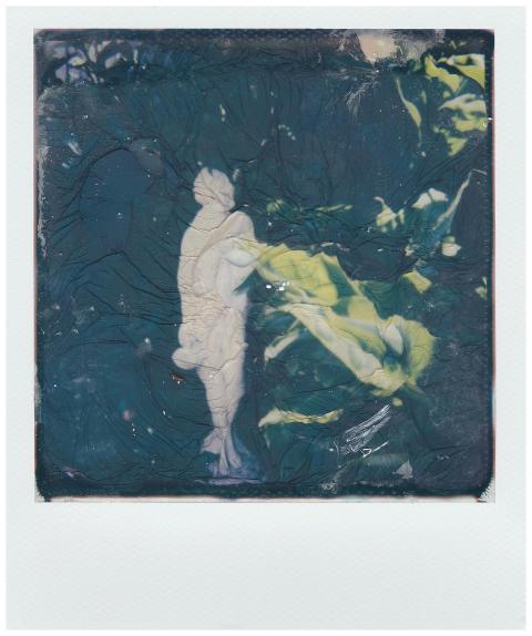 Textured abstract Polaroid art capturing a statue