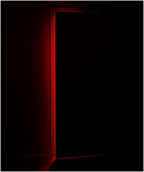 Mysterious red-lit doorway offering a peek into a