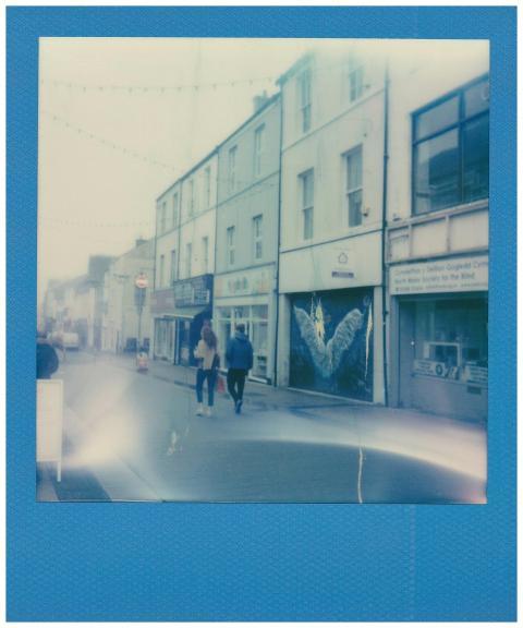 Polaroid style street photograph with two people w