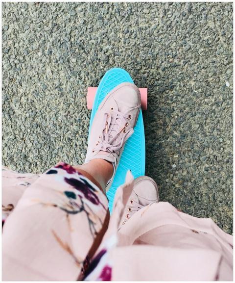 Close-up of a person skateboarding with pink sneak