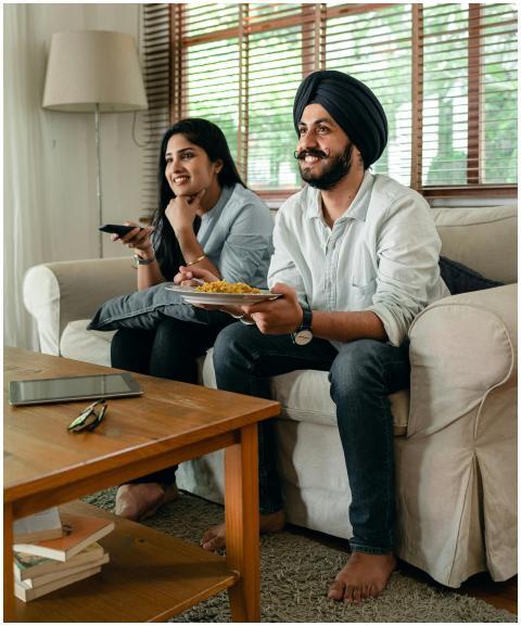 Happy Indian female and bearded male in casual clo