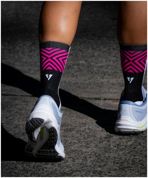 Close-up of an athlete's legs wearing pink socks a