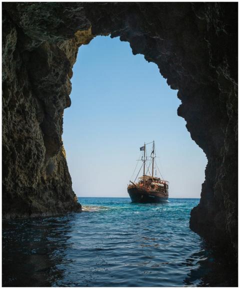 A stunning view of a ship sailing through a rocky