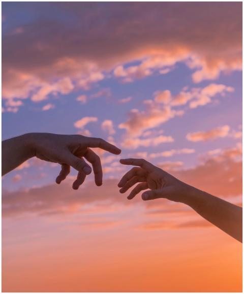 Crop anonymous people pulling hands to each other