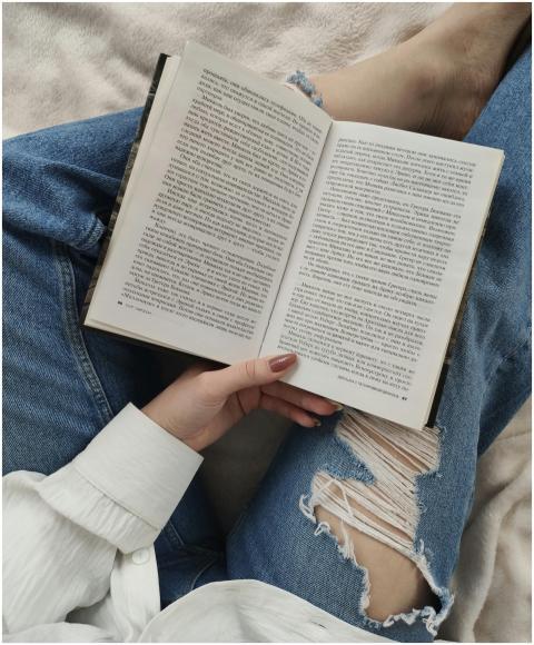 A woman enjoys a relaxing day reading a book while