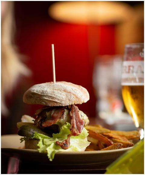 Close-up of a delicious burger with fries and beer