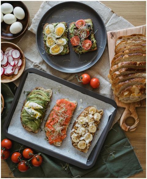 Variety of open-faced sandwiches with avocado, sal