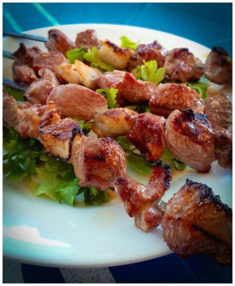 Delicious grilled meat skewers on a bed of fresh g