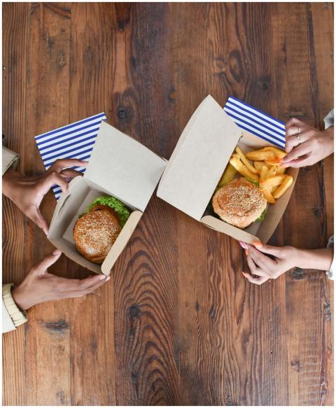 Aerial view showing two people enjoying burgers an