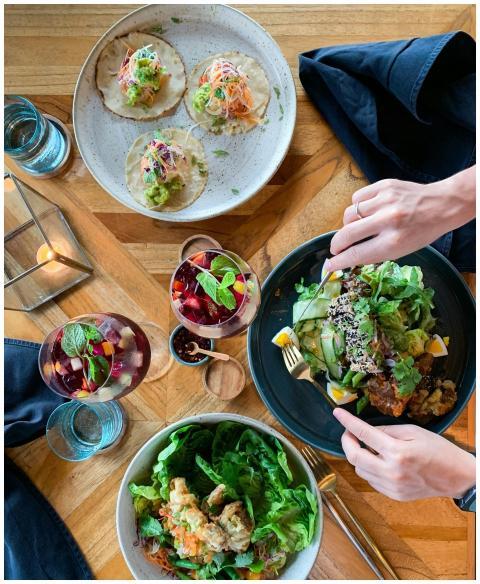 Top view of a vibrant vegetarian meal with tacos,