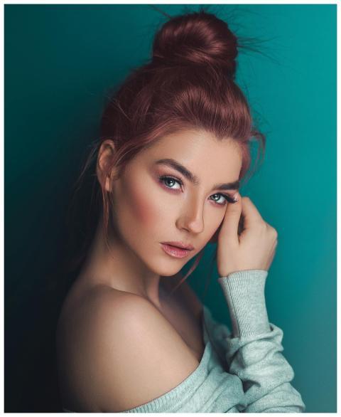 A fashionable adult woman posing with elegant make