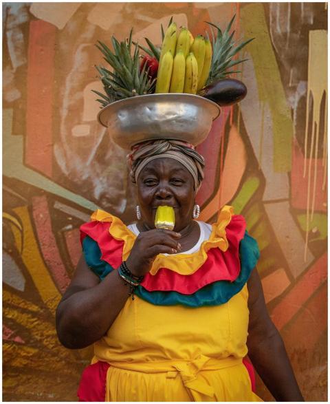Vibrant street vendor in traditional attire enjoyi