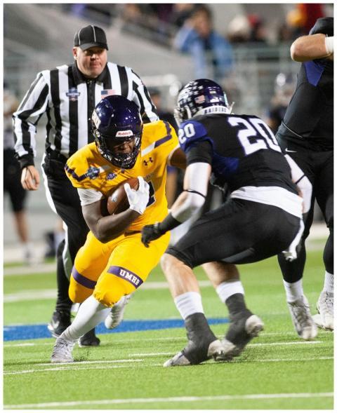 Dynamic college football game with athletes in act