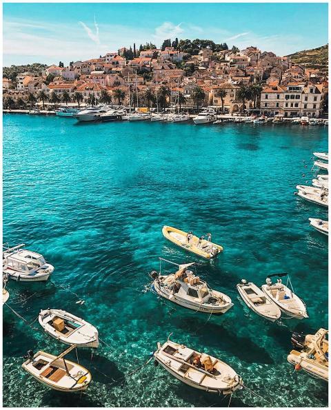 Boats in the vibrant blue waters of Hvar, Croatia,