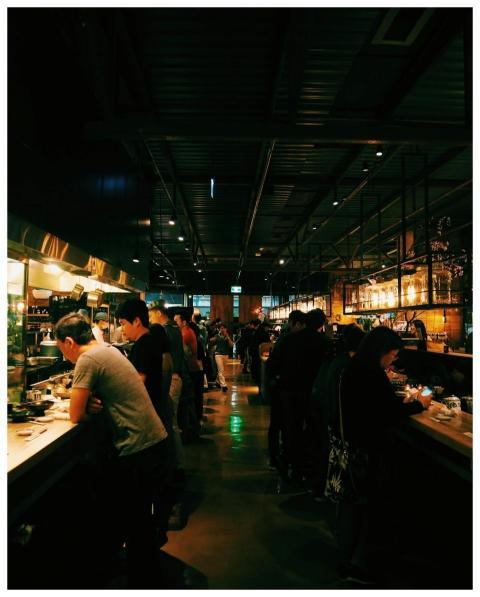 Enjoy a bustling night at a popular ramen house in