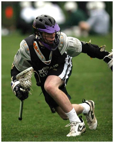 Dynamic shot of a lacrosse player mid-action durin