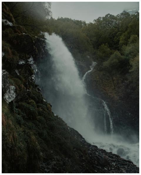 Stunning waterfall in lush Dombai forest, showcasi