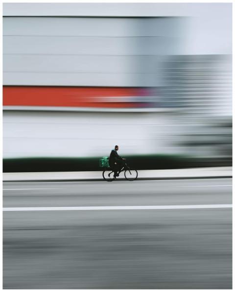 Dynamic shot of a cyclist in motion on a city stre