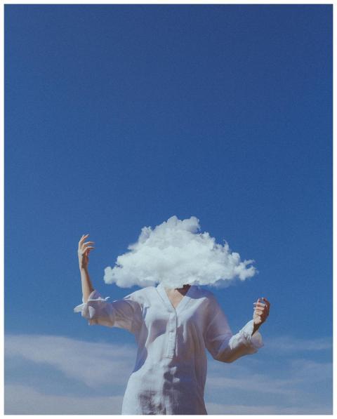 A surreal image of a woman with a cloud in place o