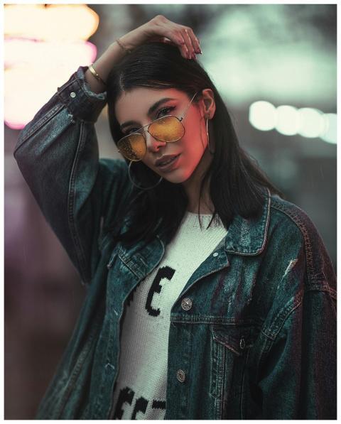 Fashionable woman posing confidently with sunglass