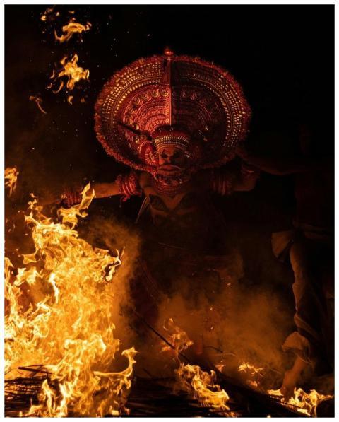 Capture of a vibrant Theyyam ritual with fire in K