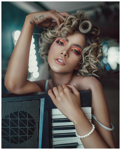 Self assured young female singer with curly hair a