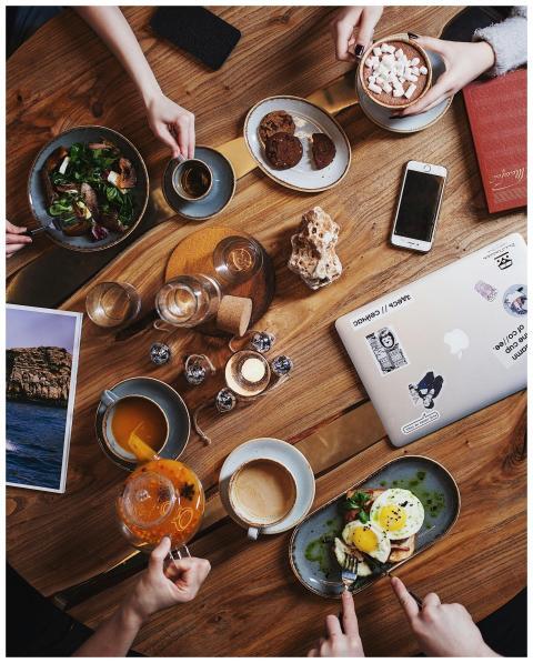A group enjoying a diverse brunch spread with coff
