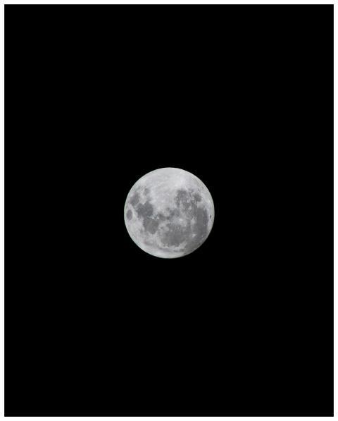 Crisp image of a full moon in grayscale against a