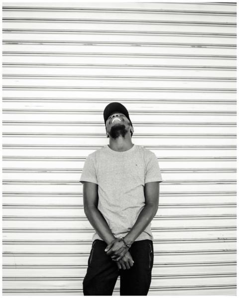 Monochrome photo of a relaxed man in a cap against