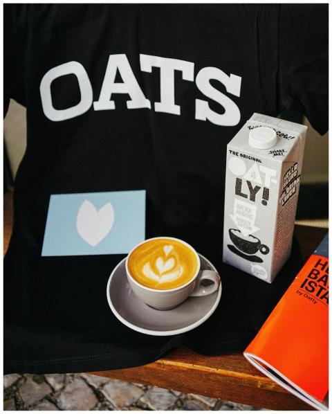 A cup of cappuccino with oat milk and froth art, a