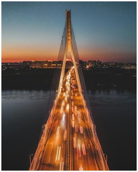 A stunning aerial shot of a suspension bridge illu