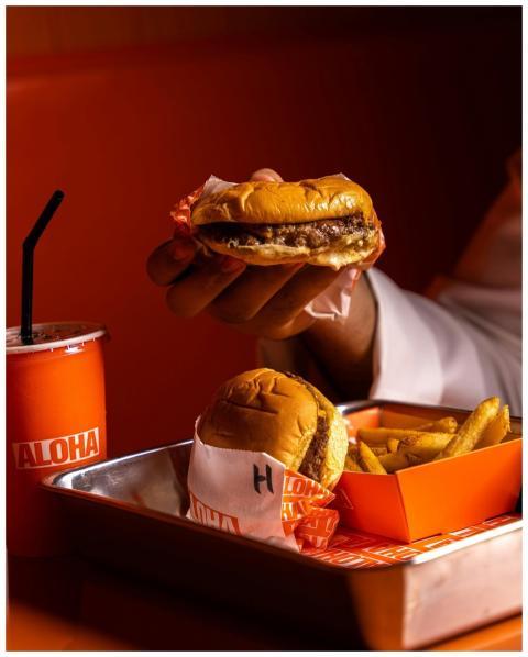 Close-up of a burger, fries, and soda served on a