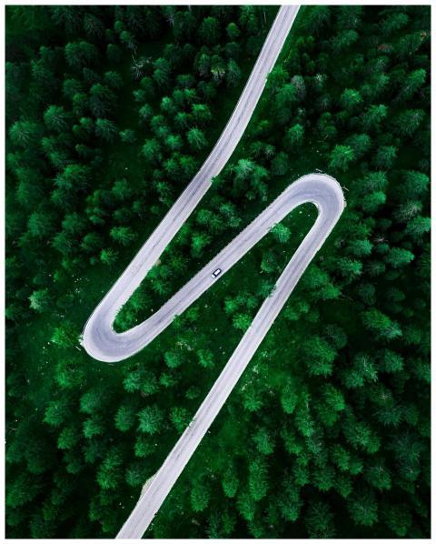 Drone shot capturing a winding road surrounded by