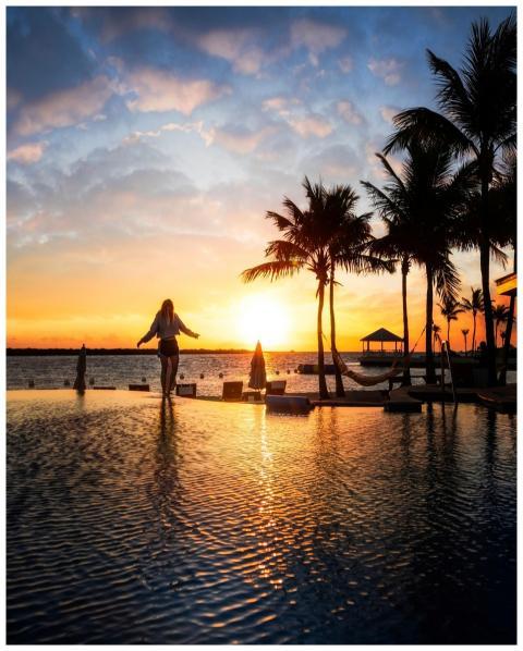 Relaxing evening scene with a woman by a tropical