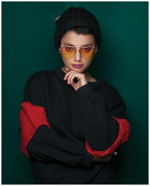 Elegant portrait of a woman in sunglasses and a kn