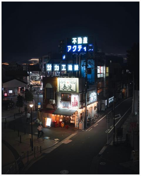 Explore the vibrant neon glow of a Tokyo street at