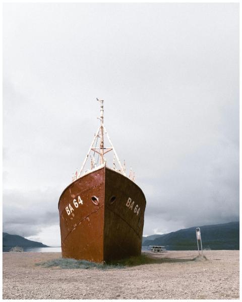 Photograph of a rusty shipwreck, BA 64, on a cloud