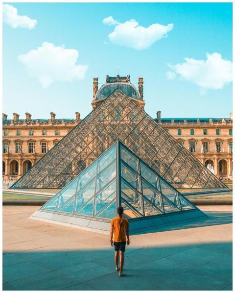 A person in front of the iconic glass pyramid at t