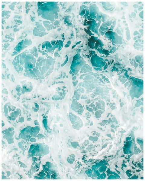 Aerial view of vibrant ocean waves and frothy seaf