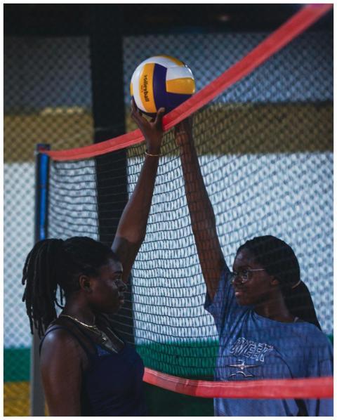 Two female athletes engaged in an intense indoor v