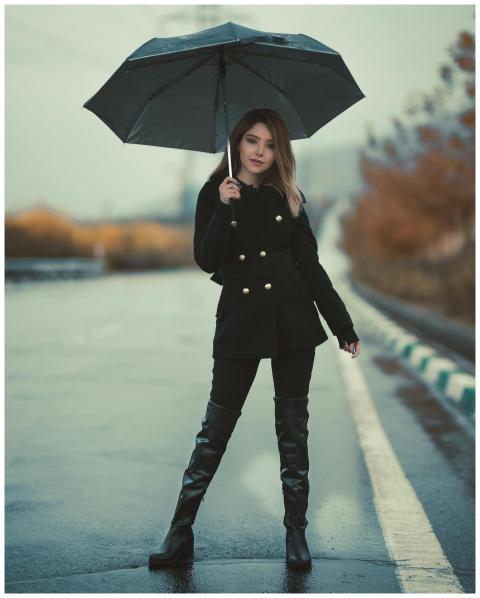 Chic woman dressed in fashionable attire holding a