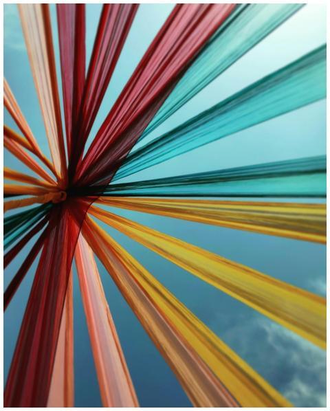 Colorful textile art installation reaching towards