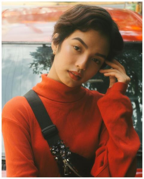 Portrait of a woman in a red turtleneck posing out