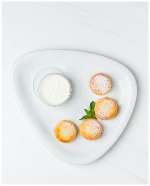 Top view of mini pastries dusted with sugar, serve
