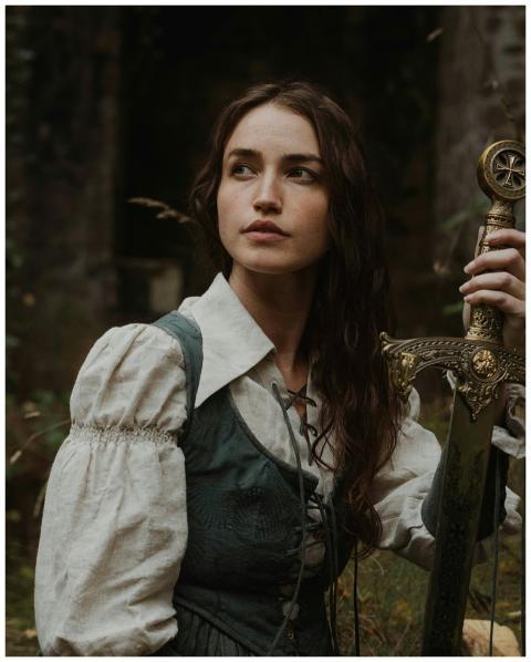 Portrait of a woman with a medieval look, holding