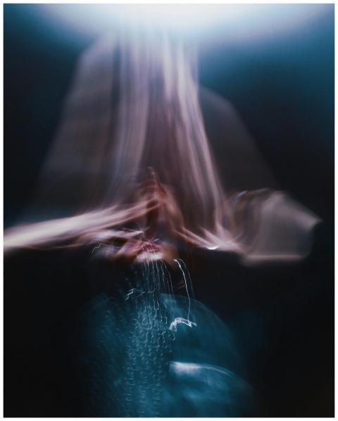 Dynamic abstract image featuring blurred light tra