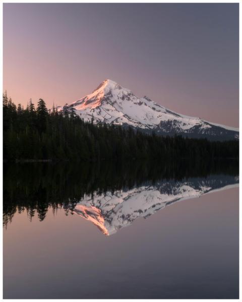 Serene sunrise over Mount Hood reflecting on a cal