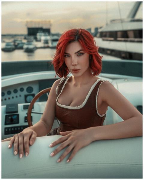 Elegant woman with red hair on a luxury yacht at D